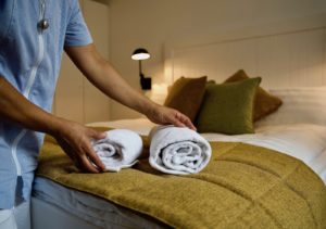 Chambermaid putting towels on the Hotel Bellagio bed